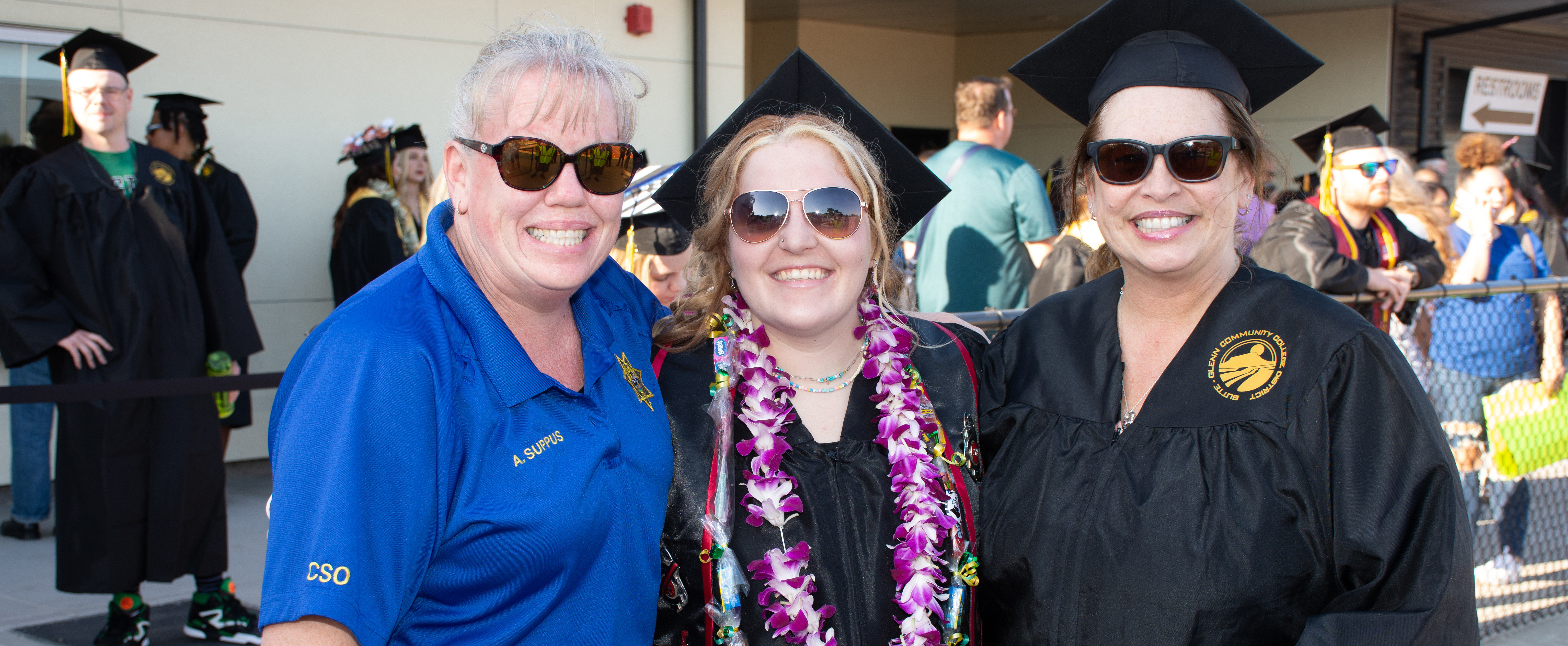 A campus safety officer congratulates graduates. 