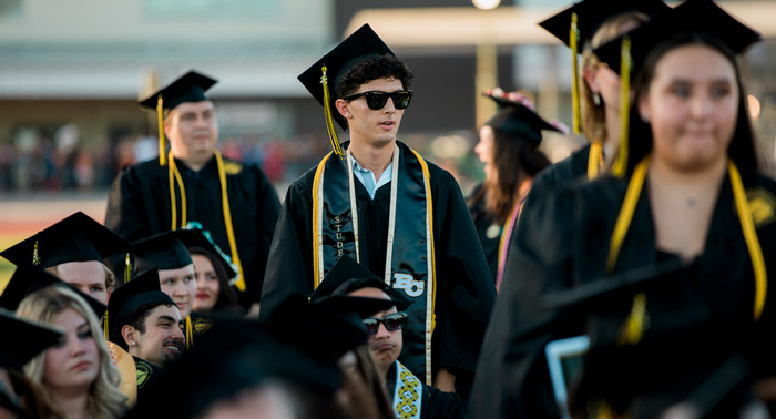 Butte College students stand at commencement.
