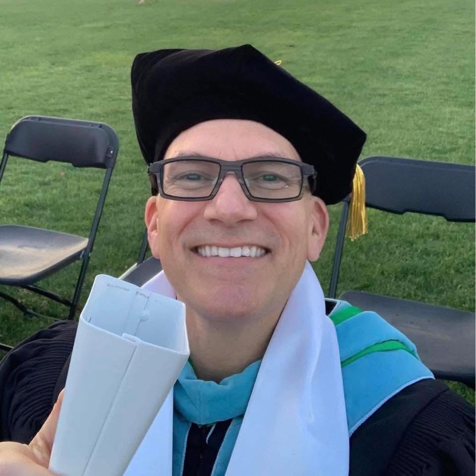 Dr. Chofla at Commencement with his celebratory cowbell