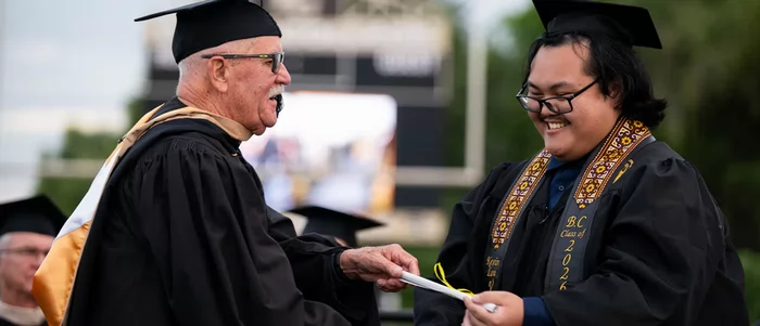 Kevin Vang receives his Butte College diploma at commencement.