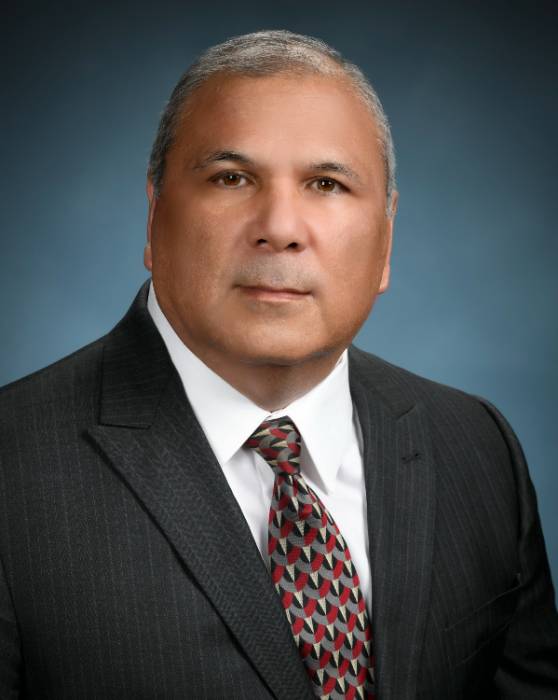 A man in a suit posed for a professional photo