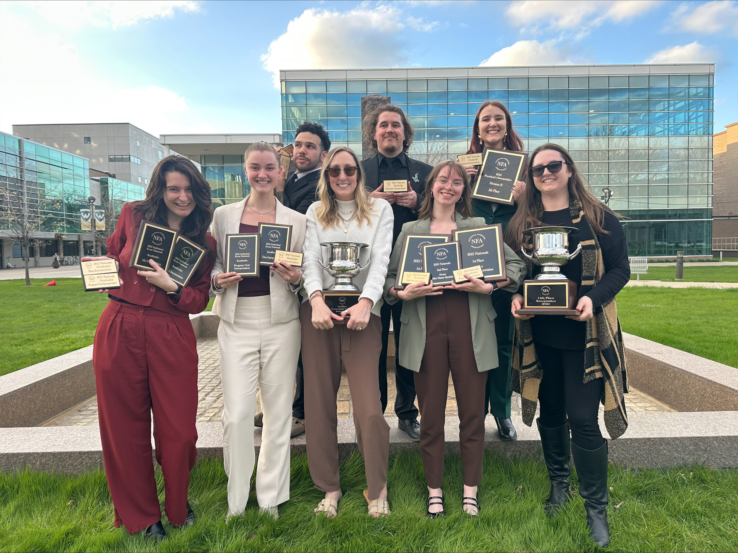 The tam displays their plaques and awards from the NFA tournament.
