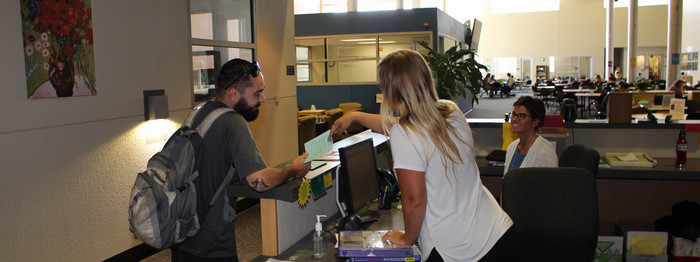 student-receieves-assistance-at-cas-center-help-desk