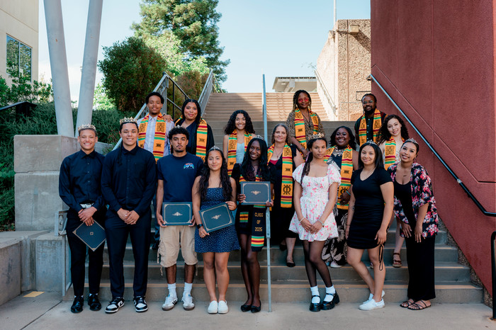 black-graduation-participants-proudly-pose-with-diplomas